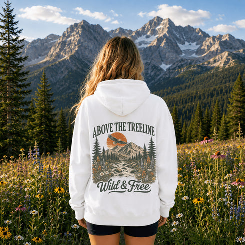 Person wearing a unisex hoodie featuring a matching left chest design and large vintage outdoor graphic on the back, photographed in scenic outdoor lifestyle settings. Available in multiple colors.
