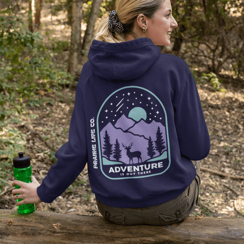 This hoodie features a graphic of a deer standing in the mountains beneath a moonlit sky, everything we love about the quiet magic of the wilderness.