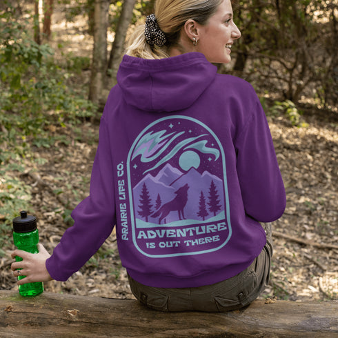 This hoodie features a wolf howling at the moon, rugged mountains, towering pines, and a breathtaking starry sky illuminated by dancing northern lights.