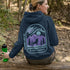 This hoodie features a wolf howling at the moon, rugged mountains, towering pines, and a breathtaking starry sky illuminated by dancing northern lights.