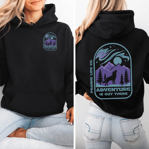 This hoodie features a wolf howling at the moon, rugged mountains, towering pines, and a breathtaking starry sky illuminated by dancing northern lights.