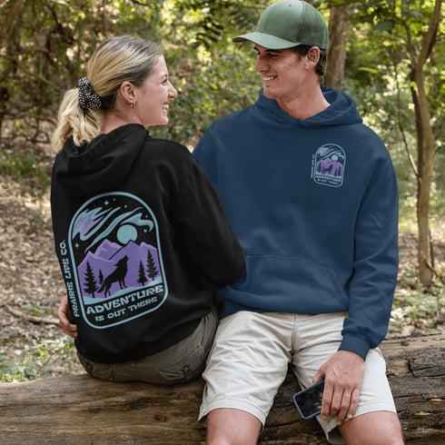 This hoodie features a wolf howling at the moon, rugged mountains, towering pines, and a breathtaking starry sky illuminated by dancing northern lights.