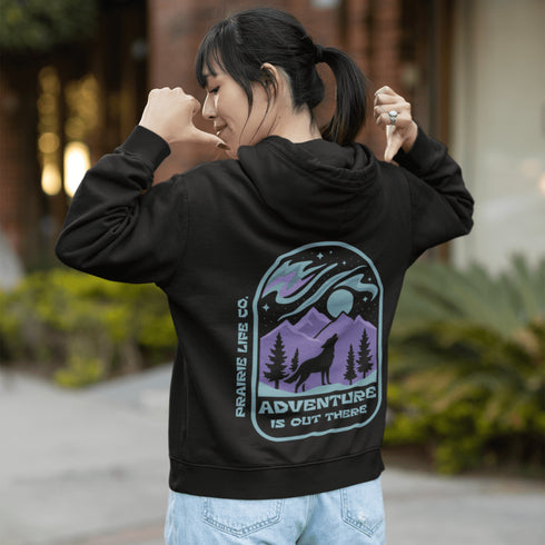 This hoodie features a wolf howling at the moon, rugged mountains, towering pines, and a breathtaking starry sky illuminated by dancing northern lights.