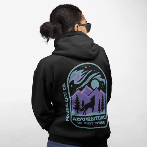 This hoodie features a wolf howling at the moon, rugged mountains, towering pines, and a breathtaking starry sky illuminated by dancing northern lights.