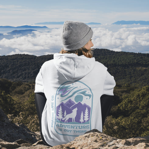 This hoodie features a wolf howling at the moon, rugged mountains, towering pines, and a breathtaking starry sky illuminated by dancing northern lights.