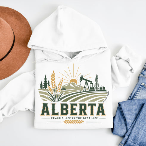 White hoodie with 'Alberta' graphic design featuring a pumpjack, wheat, and mountains on a white background.