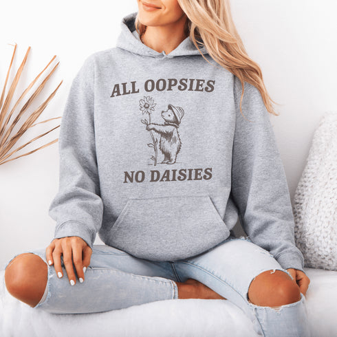 Meet your new favorite hoodie: a cuddly bear holding a giant daisy and the brutally honest mantra, "All Oopsies, No Daisies."