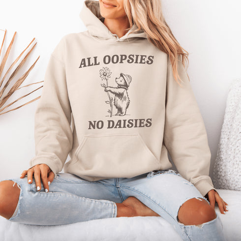 Meet your new favorite hoodie: a cuddly bear holding a giant daisy and the brutally honest mantra, "All Oopsies, No Daisies."