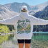 Vintage-inspired unisex hoodie featuring a small left chest graphic and a large outdoor-themed back design, photographed in lifestyle and flat lay mockups. Available in multiple colors. Perfect for hiking, camping, mountain adventures, road trips, and everyday outdoor wear.