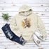 This hoodie features a beautifully detailed owl perched on a branch, surrounded by a scattering of warm-toned autumn leaves.