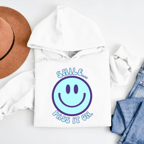 Introducing the ultimate mood booster in fabric form: the "Smile…Pass It On" Happy Face Hoodie! This isn't just any ordinary hoodie; it's a wearable ray of sunshine, guaranteed to spread joy, high-fives, and possibly even spontaneous dance-offs wherever you go.