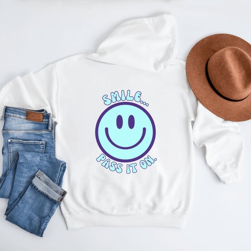 Introducing the latest must-have in your wardrobe that's guaranteed to turn frowns upside down: the Happy Face Hoodie emblazoned with the cheer-spreading command, "Smile...Pass it on." This isn't just any ordinary hoodie; it's your ticket to becoming a walking, talking (and very cozy) ambassador of joy!