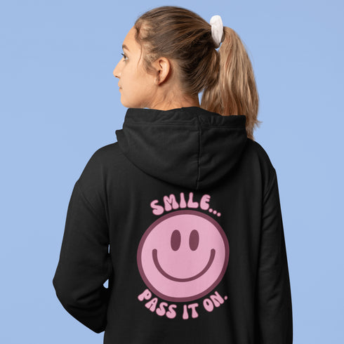 Introducing the latest must-have in your wardrobe that's guaranteed to turn frowns upside down: the Happy Face Hoodie emblazoned with the cheer-spreading command, "Smile...Pass it on." This isn't just any ordinary hoodie; it's your ticket to becoming a walking, talking (and very cozy) ambassador of joy!
