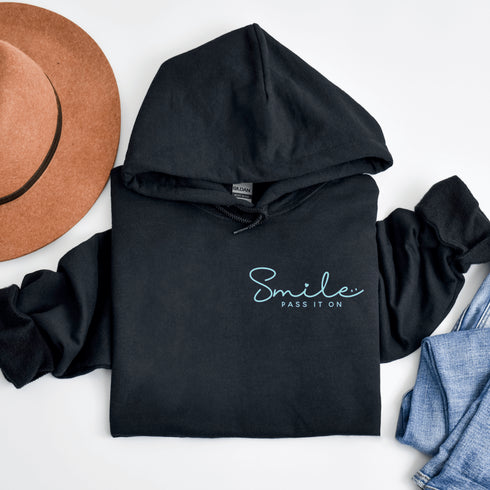 Introducing the ultimate mood lifter and smile inducer: the "Smile...Pass It On" Hoodie! Made with 100% organic cotton that's so soft, even a cactus would feel cuddly wearing it. This isn't just any hoodie; it's your wearable reminder to the world that happiness is contagious, and it starts with a simple smile.