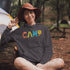 Introducing our vibrant and adventurous camping hoodie! Featuring bold and colorful "Camp" letters adorned with charming camping icons cut out, this shirt is perfect for outdoor enthusiasts and nature lovers alike.