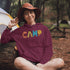 Introducing our vibrant and adventurous camping hoodie! Featuring bold and colorful "Camp" letters adorned with charming camping icons cut out, this shirt is perfect for outdoor enthusiasts and nature lovers alike.