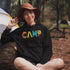 Introducing our vibrant and adventurous camping hoodie! Featuring bold and colorful "Camp" letters adorned with charming camping icons cut out, this shirt is perfect for outdoor enthusiasts and nature lovers alike.