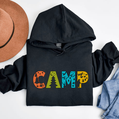 Introducing our vibrant and adventurous camping hoodie! Featuring bold and colorful "Camp" letters adorned with charming camping icons cut out, this shirt is perfect for outdoor enthusiasts and nature lovers alike.