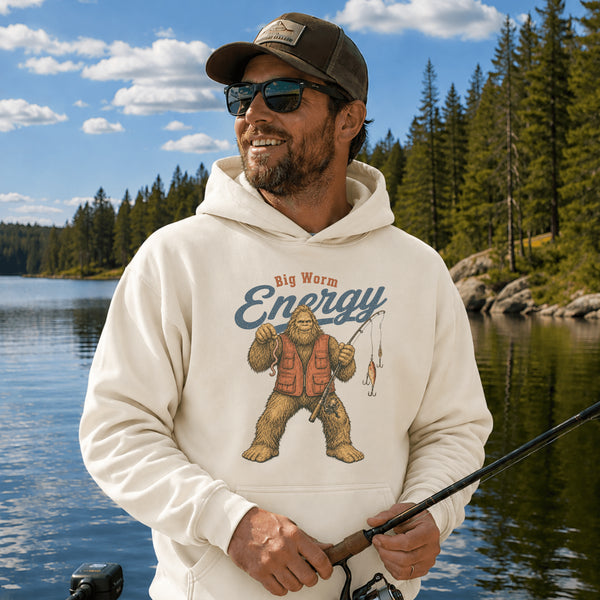 Unisex Gildan 18500 hoodie featuring a vintage-style Bigfoot fishing graphic with the phrase "Big Worm Energy," available in multiple colors.