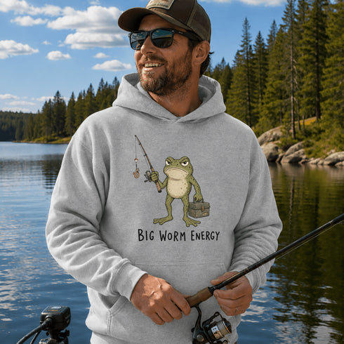 Unisex heavy blend hoodie featuring a funny frog fishing graphic and humorous Big Worm Energy design shown in various lifestyle mockups and outdoor settings.