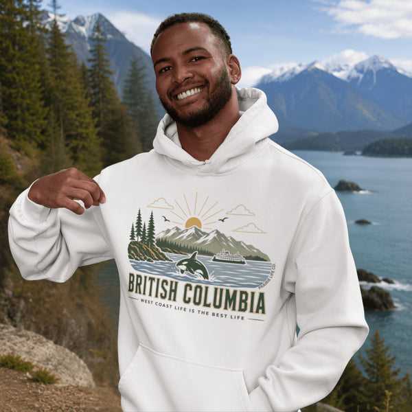 Man wearing a white hoodie with 'British Columbia' design in front of a scenic mountain and lake background