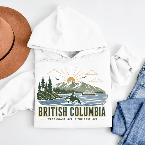 White hoodie with 'British Columbia' design featuring mountains, trees, and a ship on a white background.