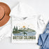 White hoodie with 'British Columbia' design featuring mountains, trees, and a ship on a white background.
