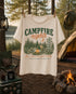 Vintage Campfire Nights camping graphic t-shirt featuring a retro forest campsite with a glowing campfire, tent, pine trees, and outdoor adventure design.