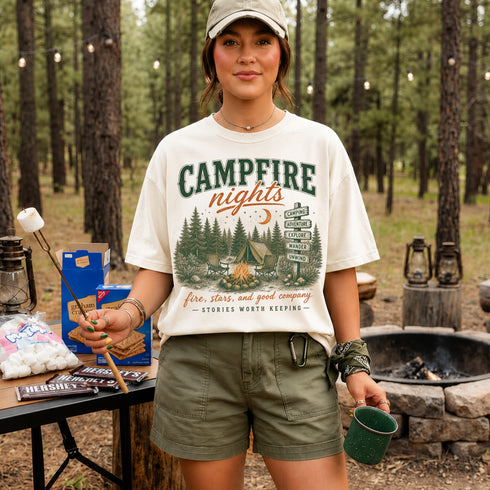 Vintage Campfire Nights camping graphic t-shirt featuring a retro forest campsite with a glowing campfire, tent, pine trees, and outdoor adventure design.