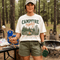 Vintage Campfire Nights camping graphic t-shirt featuring a retro forest campsite with a glowing campfire, tent, pine trees, and outdoor adventure design.