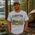 Vintage Campfire Nights camping graphic t-shirt featuring a retro forest campsite with a glowing campfire, tent, pine trees, and outdoor adventure design.
