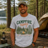 Vintage Campfire Nights camping graphic t-shirt featuring a retro forest campsite with a glowing campfire, tent, pine trees, and outdoor adventure design.