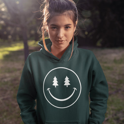 Introducing the latest in outdoor fashion and forest friendliness: the "Tree-mendous Smiles Hoodie"! This isn't just any hoodie; it's your ticket to becoming the most smiley face in the wild. With a dazzling happy face emblazoned on the front, you're set to spread joy among the trees, the birds, and even the most stubborn of rocks.