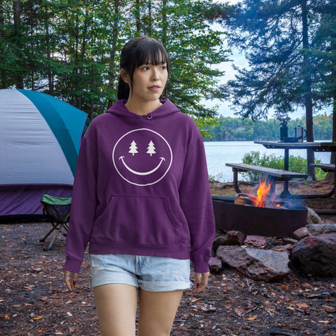 Introducing the latest in outdoor fashion and forest friendliness: the "Tree-mendous Smiles Hoodie"! This isn't just any hoodie; it's your ticket to becoming the most smiley face in the wild. With a dazzling happy face emblazoned on the front, you're set to spread joy among the trees, the birds, and even the most stubborn of rocks.
