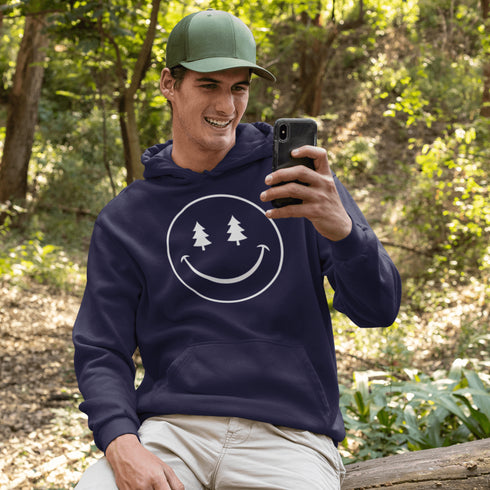 Introducing the latest in outdoor fashion and forest friendliness: the "Tree-mendous Smiles Hoodie"! This isn't just any hoodie; it's your ticket to becoming the most smiley face in the wild. With a dazzling happy face emblazoned on the front, you're set to spread joy among the trees, the birds, and even the most stubborn of rocks.