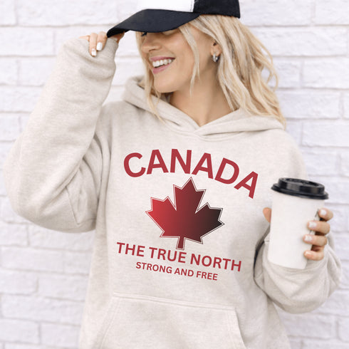 White Canada hoodie with bold maple leaf design and “True North Strong and Free” text, unisex Canadian sweatshirt