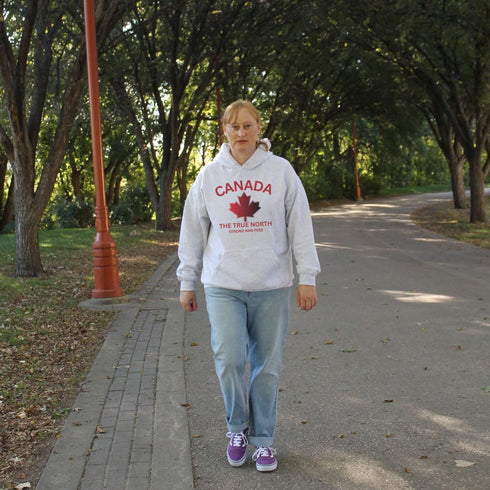Canadian “True North Strong and Free” hoodie in light grey with red maple leaf graphic, cozy unisex Canada pride sweatshirt