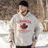 White Canada hoodie with bold maple leaf design and “True North Strong and Free” text, unisex Canadian sweatshirt