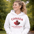 White Canada hoodie with bold maple leaf design and “True North Strong and Free” text, unisex Canadian sweatshirt