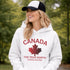 White Canada hoodie with bold maple leaf design and “True North Strong and Free” text, unisex Canadian sweatshirt