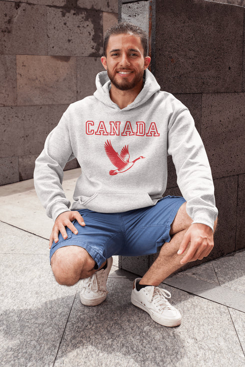 This hoodie celebrates the Canadian goose, wings spread wide, flying across Canada (and probably plotting its next lawn invasion).