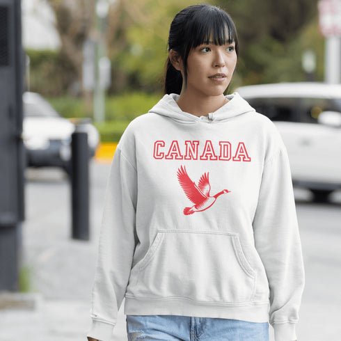 This hoodie celebrates the Canadian goose, wings spread wide, flying across Canada (and probably plotting its next lawn invasion).