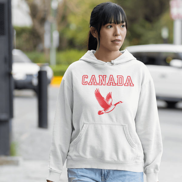 This hoodie celebrates the Canadian goose, wings spread wide, flying across Canada (and probably plotting its next lawn invasion).