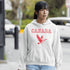 This hoodie celebrates the Canadian goose, wings spread wide, flying across Canada (and probably plotting its next lawn invasion).