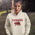 Meet the Plaid & Proud Hoodie, featuring a rugged red & black plaid bear alongside "Canada" in matching plaid lettering—because nothing says “True North strong” like a bear rocking Canadian flannel.