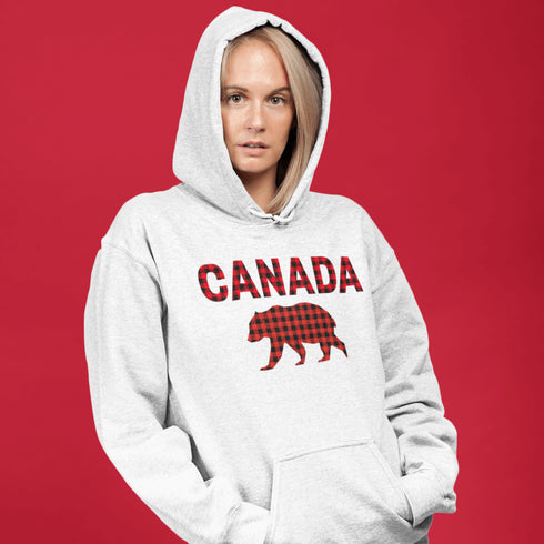 Meet the Plaid & Proud Hoodie, featuring a rugged red & black plaid bear alongside "Canada" in matching plaid lettering—because nothing says “True North strong” like a bear rocking Canadian flannel.