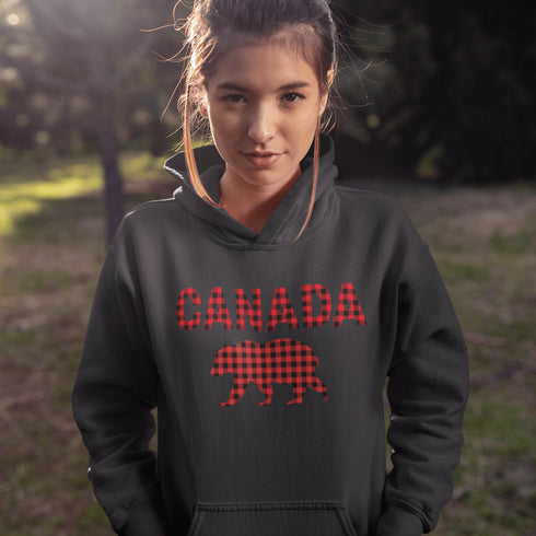 Meet the Plaid & Proud Hoodie, featuring a rugged red & black plaid bear alongside "Canada" in matching plaid lettering—because nothing says “True North strong” like a bear rocking Canadian flannel.