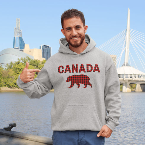 Meet the Plaid & Proud Hoodie, featuring a rugged red & black plaid bear alongside "Canada" in matching plaid lettering—because nothing says “True North strong” like a bear rocking Canadian flannel.