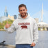 Meet the Plaid & Proud Hoodie, featuring a rugged red & black plaid bear alongside "Canada" in matching plaid lettering—because nothing says “True North strong” like a bear rocking Canadian flannel.