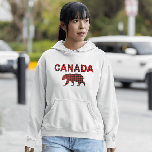 Meet the Plaid & Proud Hoodie, featuring a rugged red & black plaid bear alongside "Canada" in matching plaid lettering—because nothing says “True North strong” like a bear rocking Canadian flannel.